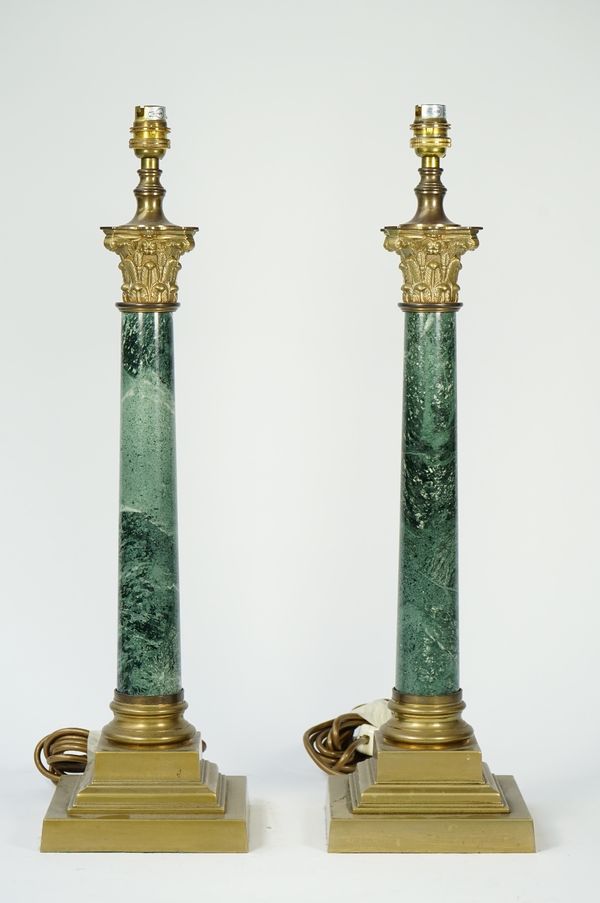 A pair of Victorian style faux Verde marble and brass mounted table lamps of Corinthian column form, 47cm high with a pair of cream silk pleated shade