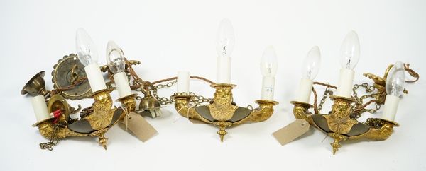 A set of three Empire style three light gilt and patinated bronze chandeliers, 20th century, each triform body with foliate cast decoration suspended