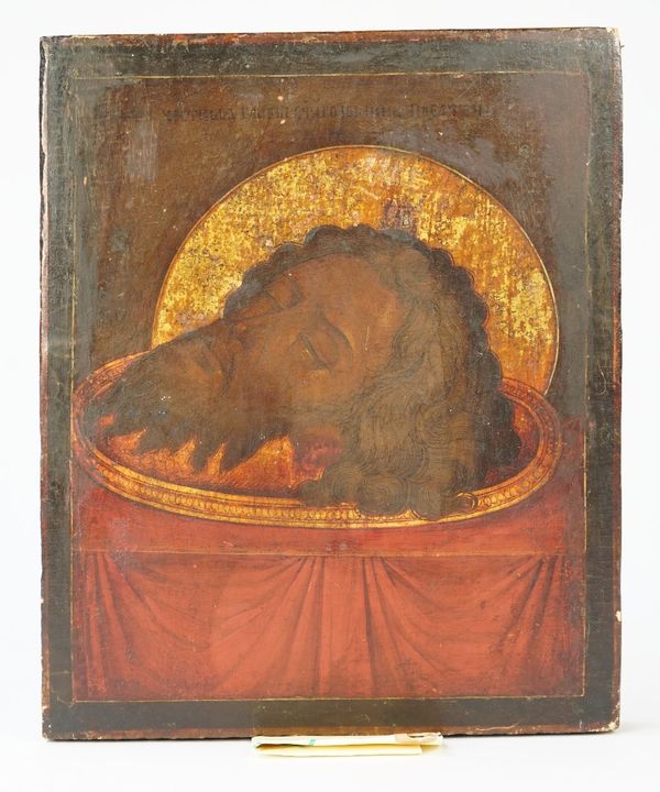 A Russian Icon depicting the severed head of St John the Baptist, late 19th/early 20th century, polychrome painted against a rectangular pine board, 2