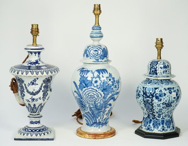 A Dutch Delft blue vase and cover, converted to a table lamp, decorated with flowers against a baluster ground, 40cm high, another similar smaller blu