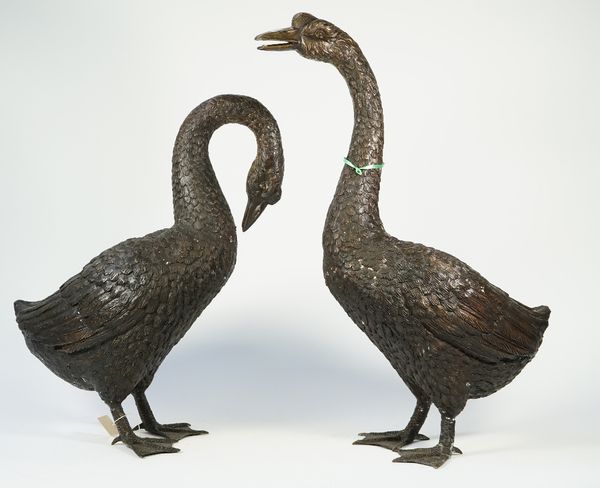 Two modern patinated bronze geese, each modelled standing, unsigned, 65cm high, (2).