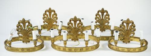 A set of three 19th century bronze four light wall appliques, of oval banded form with a foliate cast back pate, 25cm high, and two matching two branc