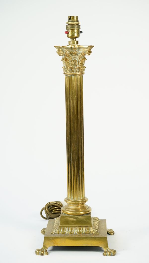 A Victorian gilt bronze table lamp of Corinthian column form, raised on a square base and four lion paw feet, 50cm high.