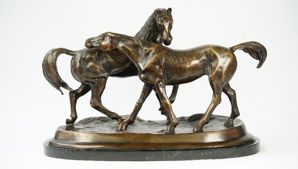 A modern patinated bronze equestrian group depicting two horses on a naturalistic base and marble shaped plinth, unsigned, 68cm wide.