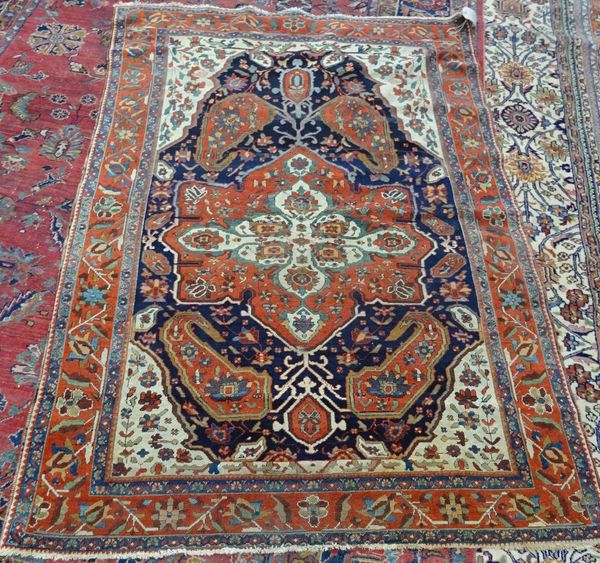 A Fereghan rug, Persian, the dark indigo field with a bold madder medallion with large boteh ends, ivory spandrels, with floral sprays, a madder roset