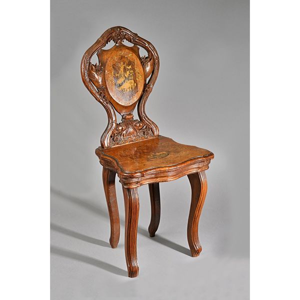 A late 19th century Black Forest musical child's chair marquetry inlaid with shepherd and goats, 33cm wide x 71cm high. Illustrated