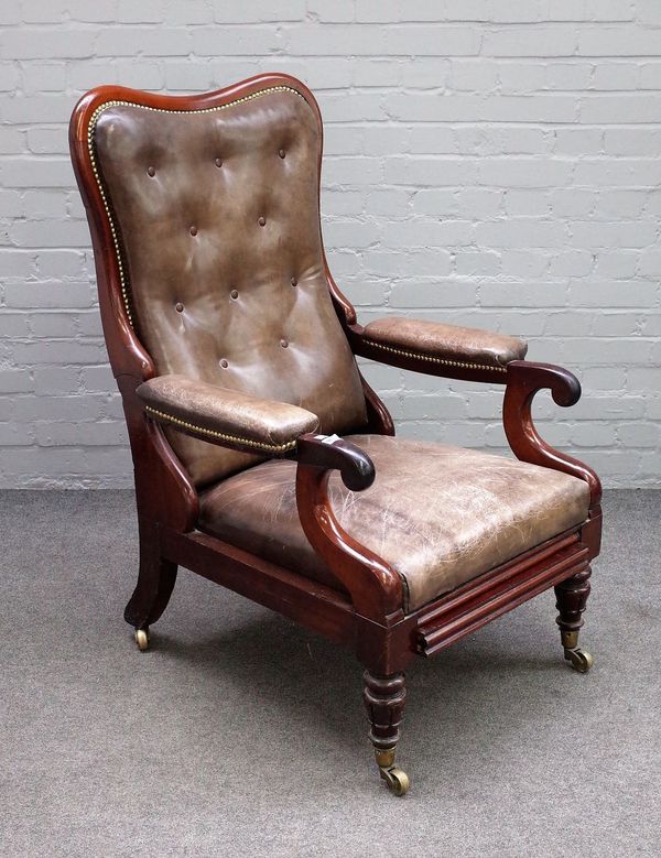 An early Victorian mahogany framed leather upholstered open arm easy chair, with slide out integral footrest, 62cm wide x 115cm high.