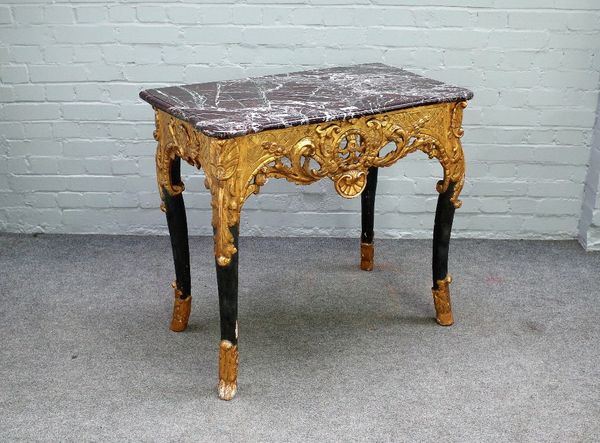 An 18th century Continental console, the serpentine marble top over a parcel gilt green painted base with pierced and carved frieze on four turned sup