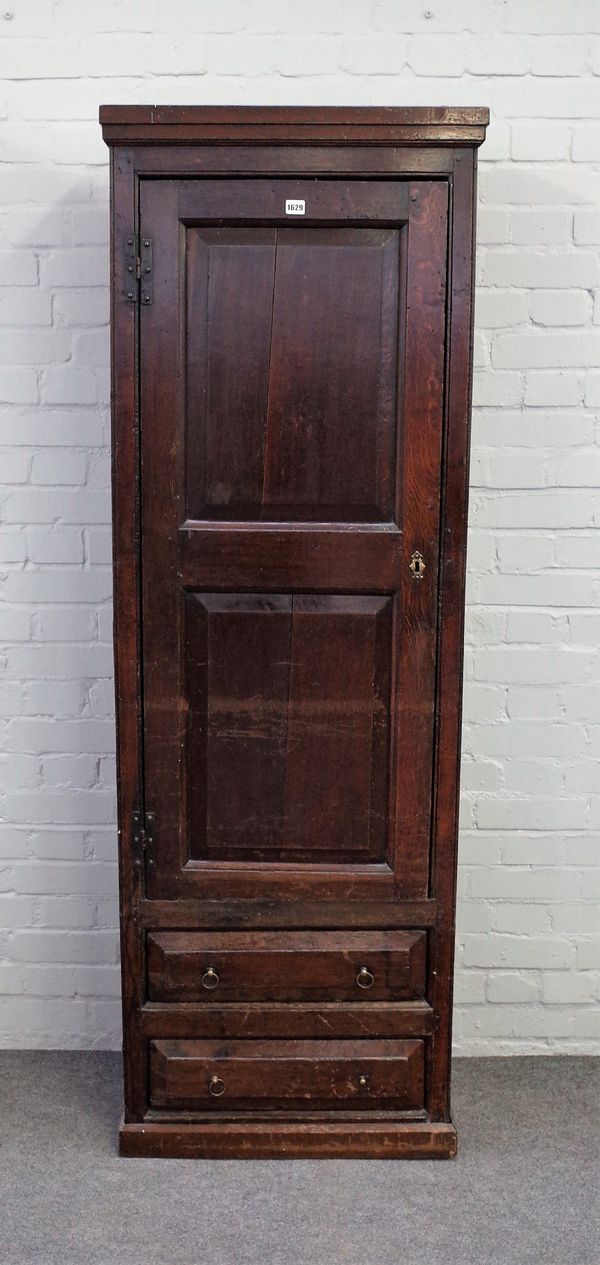 A 17th century and later tall/ narrow cupboard with double raised panel door over pair of drawers, 64cm wide x 188cm high.