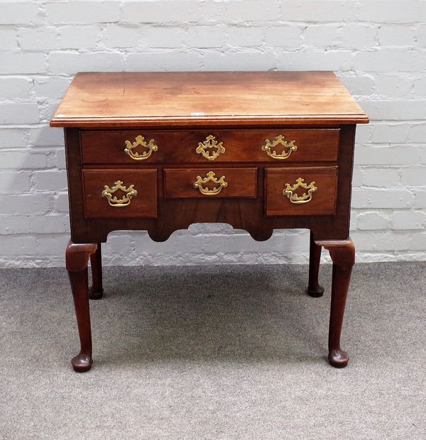 A mid-18th century mahogany and walnut lowboy, the shaped frieze with four drawers on club supports, 77cm wide x 72cm high.