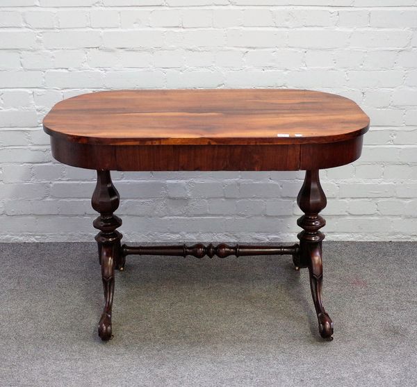 A Victorian rosewood writing table, the oval top with single frieze drawer on octagonal baluster columns and four downswept supports, 102cm wide x 71c