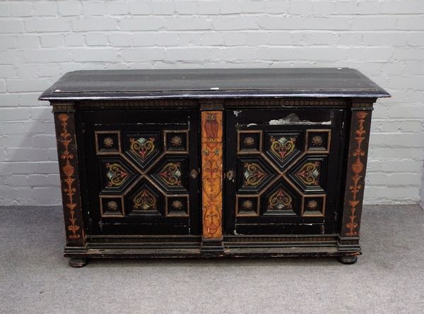 A Victorian Gothic revival ebonised and polychrome painted side cabinet with pair of geometric moulded doors, 146cm wide x 81cm high.