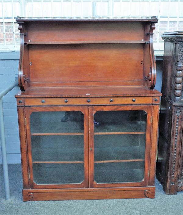 A 19th century mahogany side cabinet, the scroll mounted shelf back over a pair of glazed doors, 127cm wide x 164cm high.