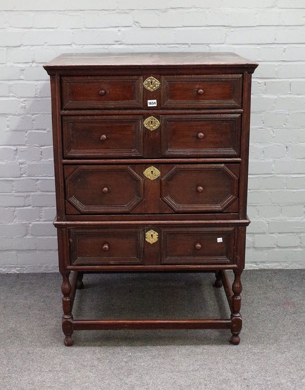 A 17th century and later oak chest on stand, with three long geometric drawers over single drawer base, on turned supports, 76cm wide x 111cm high.