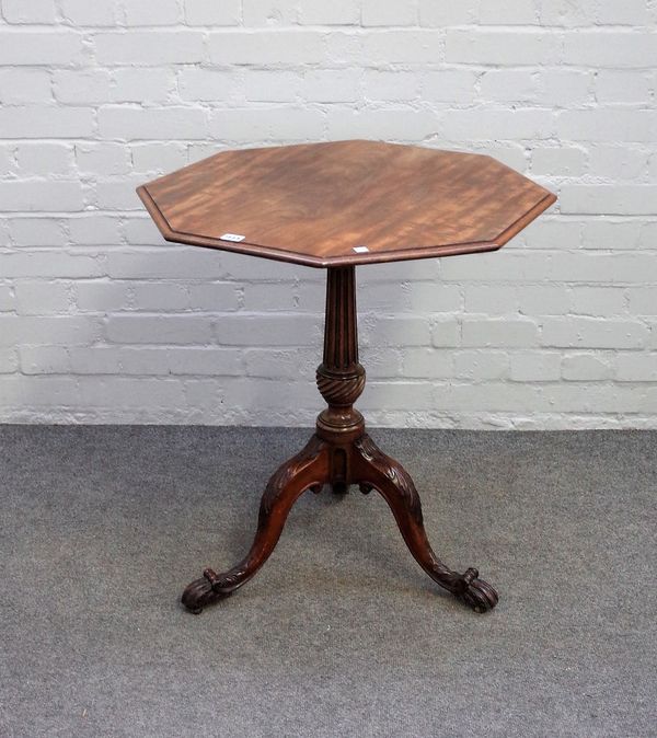 A George III and later mahogany occasional table, the octagonal oval snap top on fluted column and carved tripod base, 65cm wide x 71cm high.