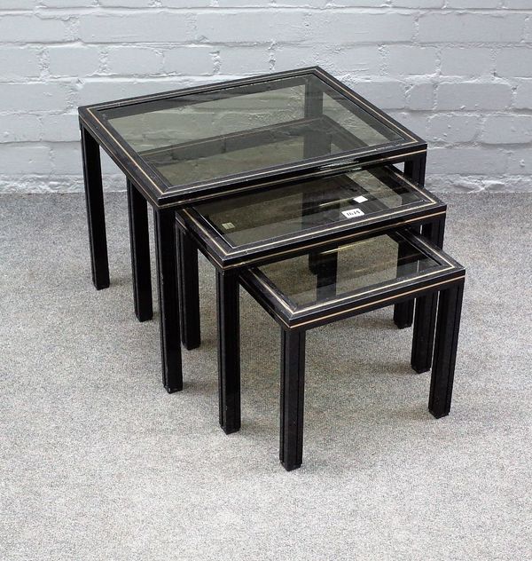 PIERRE VANDEL PARIS; a nest of three glass inset metal occasional tables, the larger 50cm wide x 38cm high.