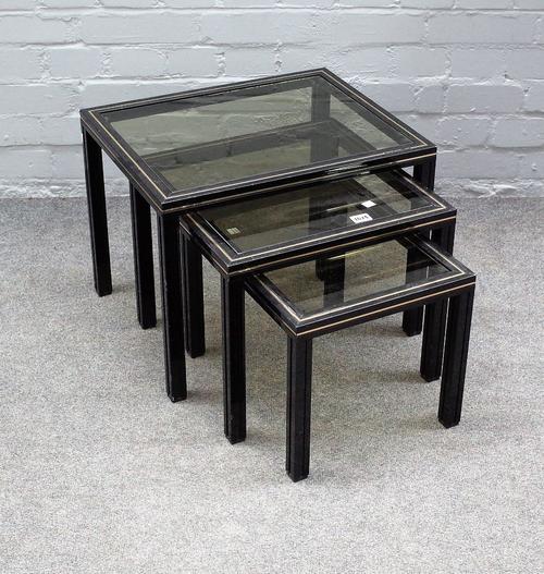 PIERRE VANDEL PARIS; a nest of three glass inset metal occasional tables, the larger 50cm wide x 38cm high.
