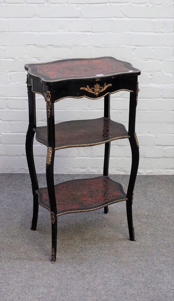 A late 19th century ebonised boulle work gilt metal mounted three tier etagere of serpentine outline with single frieze drawer, 48cm wide x 87cm high.