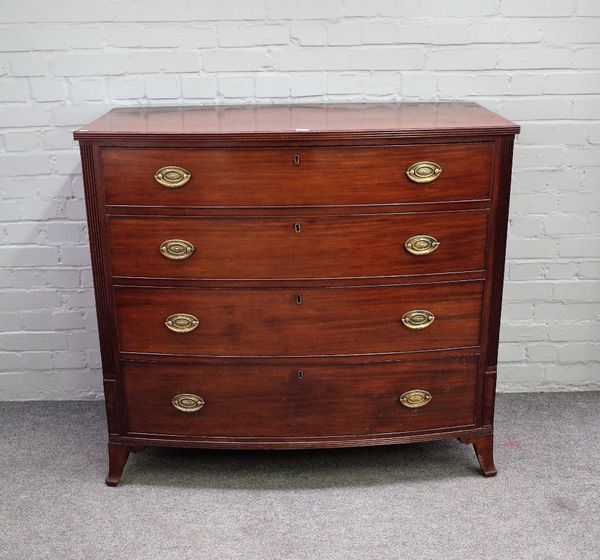 A Regency mahogany bowfront chest of four long graduated drawers, flanked by fluted corners on splayed bracket feet, 115cm wide x 104cm high.