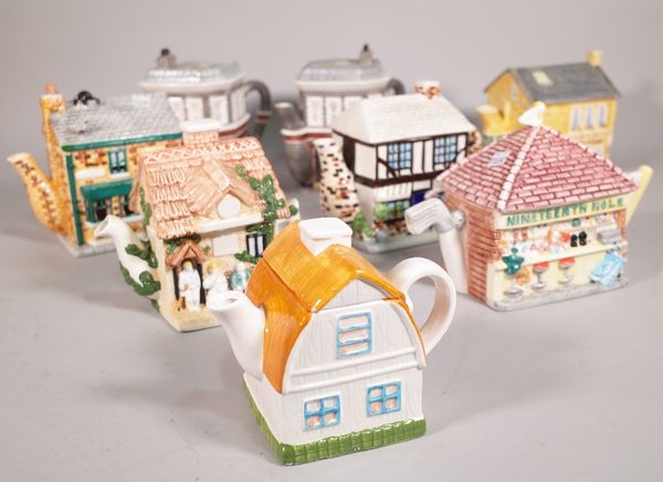 A group of eight 20th century novelty tea pots formed as houses, the largest 16cm high, (8). S5M