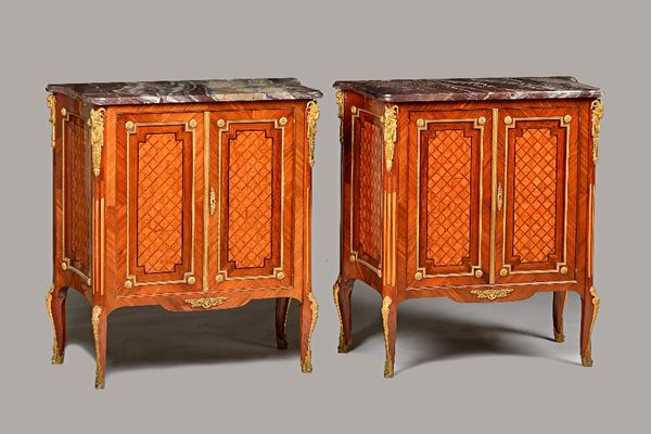 A pair of 18th century French style commodes, each with shaped marble tops over gilt metal mounted kingwood and mahogany two door bases on slender cab