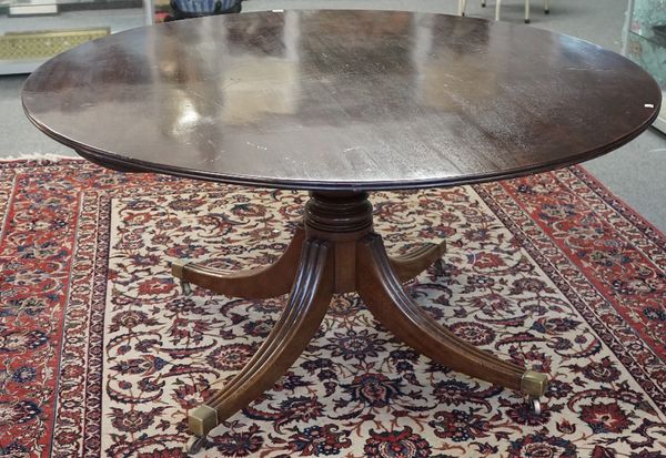 A George III mahogany breakfast table, the circular snap top on turned column and four downswept supports, 144cm diameter x 74cm high.