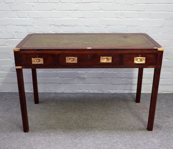 A campaign style brass bound mahogany three draw writing desk, on channelled square supports, 119cm wide x 79cm high.