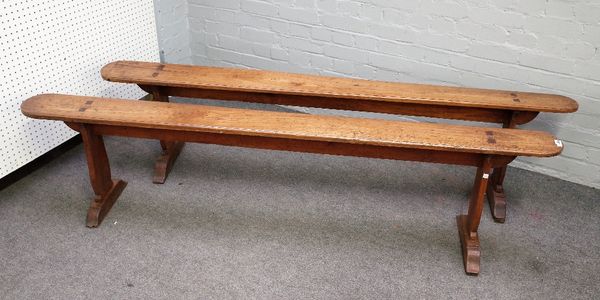 A pair of 19th century French fruitwood benches on silhouette trestle supports, 200cm wide x 48cm high.