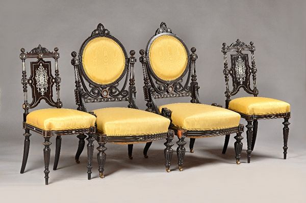 A 19th century ivory marquetry inlaid ebonised salon suite to comprise; open arm sofa, 145cm wide x 110cm high, two armchairs 60cm wide x 107cm high,