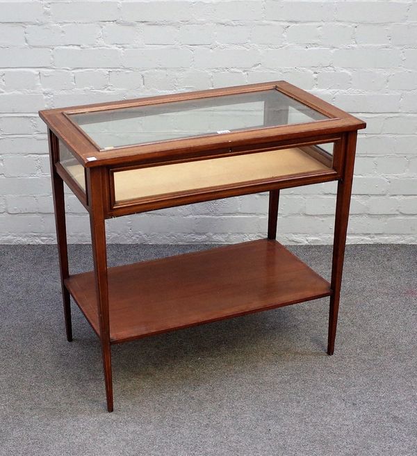 A late 19th century inlaid mahogany rectangular bijouterie table, on tapering square supports, united by platform undertier, 74cm wide x 72cm high.