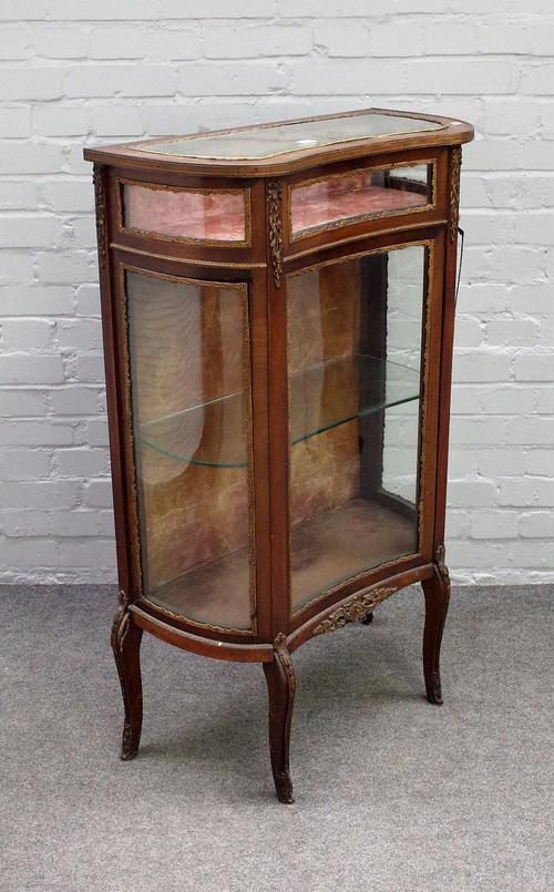 A late 19th century French gilt-metal mounted mahogany concave fronted bijouterie cabinet with hinged top over single glaze door on slender cabriole s