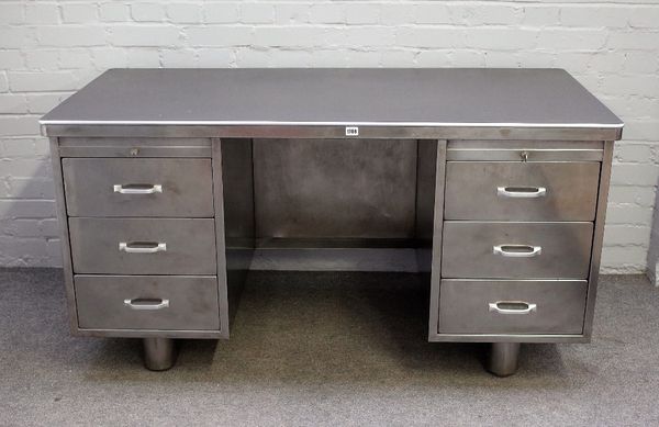 A polished steel office desk of industrial design, with six pedestal drawers, 151cm wide x 76cm high.