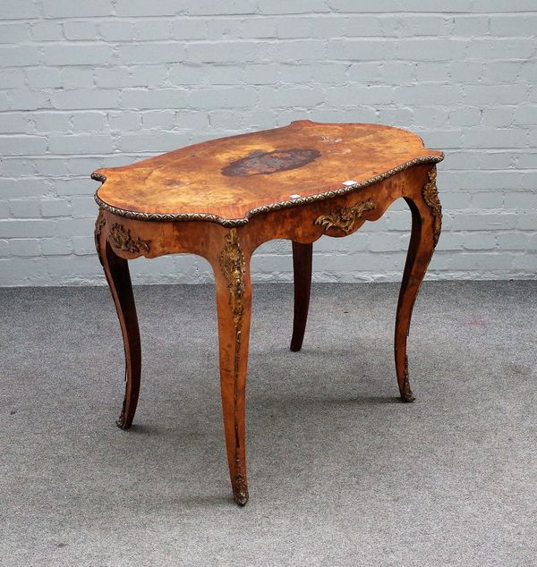 A Victorian gilt metal mounted marquetry inlaid figured walnut centre table, with shaped oval top, on cabriole supports, 101cm wide x 76cm high.