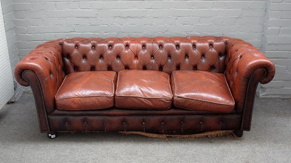 A 20th century button back brown leather upholstered Chesterfield sofa, on turned feet, 195cm wide x 67cm high.