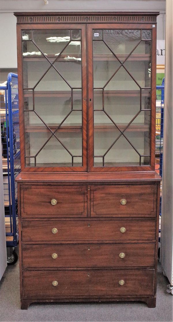 An early 19th century inlaid mahogany secretaire cabinet with pair of astragal glazed doors over fitted drawer and three further long drawers on brack