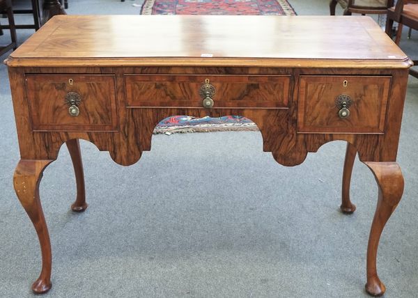 A Queen Anne style figured walnut low boy, with three frieze drawers on cabriole supports, 117cm wide x 80cm high.