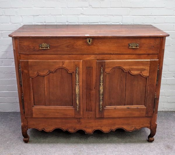 An early 19th century French walnut buffet, with single drawer over pair of shaped panel cupboards on scroll supports, 132cm wide x 106cm high.