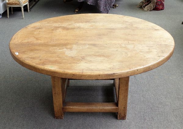 An 18th century style oak circular dining table on block supports and stretchers, 149cm diameter x 76cm high.