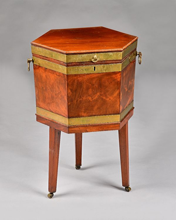 A George III brass bound mahogany hexagonal wine cooler with hinged lid on three tapering square supports, 50cm wide x 69cm high.