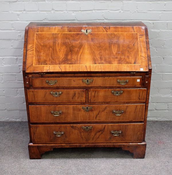 An 18th century figured walnut bureau, the fitted interior over one long, two short and two further long drawers on bracket feet, 89cm wide x 99cm hig