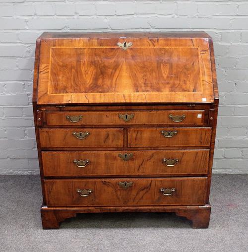 An 18th century figured walnut bureau, the fitted interior over one long, two short and two further long drawers on bracket feet, 89cm wide x 99cm hig