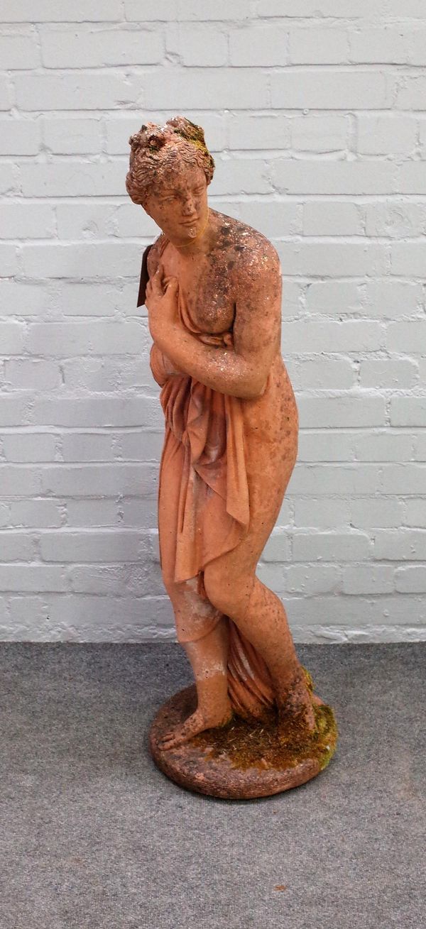 A reconstituted stone figure of bathing Venus, in standing pose, on circular base, 117cm high.