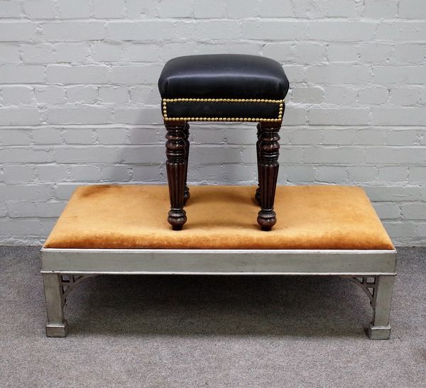 An 18th century style rectangular footstool with silver painted frame on canted block supports, 107cm wide x 33cm high together with a William IV styl