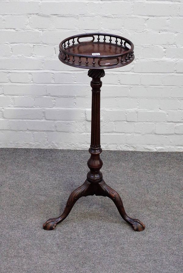 A 19th century Georgian revival torchere, the galleried circular top on fluted column and three ball and claw supports,  85cm high.