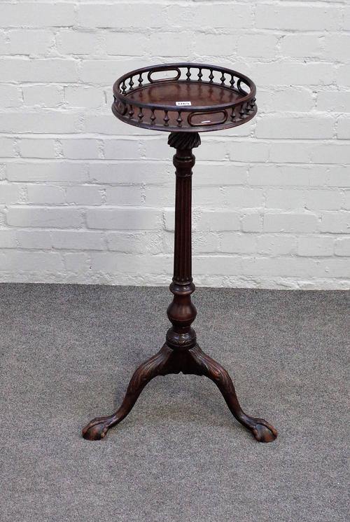 A 19th century Georgian revival torchere, the galleried circular top on fluted column and three ball and claw supports,  85cm high.