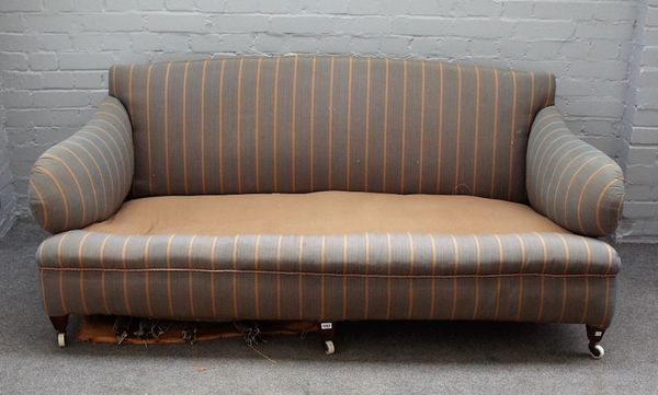 An early 20th century Howard style sofa with shaped arms and sides on tapering square walnut supports, 175cm wide x 77cm high.