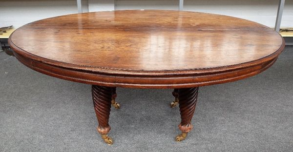 A 19th century Anglo Indian teak dining table, the oval top on four spiral fluted supports, 185cm wide x 77cm high.