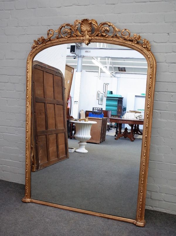 A Victorian gilt framed arch top overmantel mirror, with shell and acanthus scroll crest, 122cm x 173cm high.