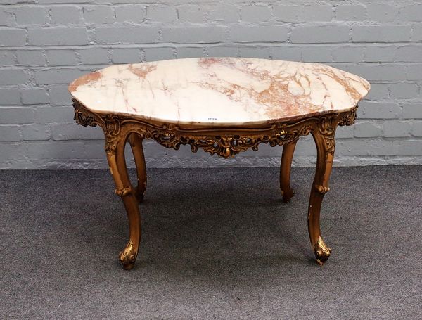 A Rococo revival coffee table, the shaped oval marble top on a pierced and carved giltwood base with four scroll supports, 91cm wide x 51cm high.