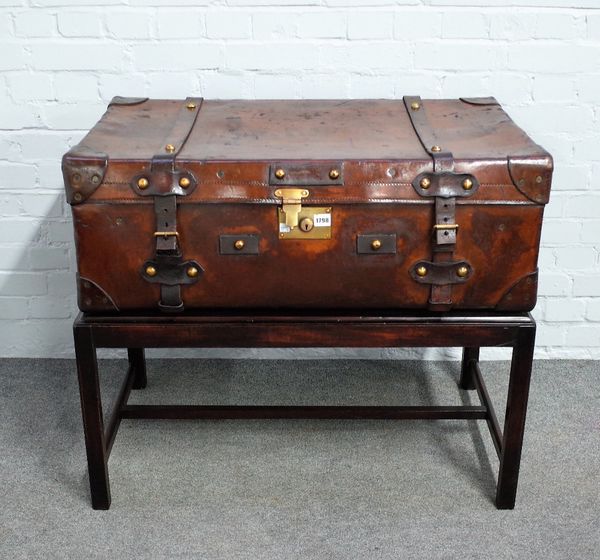 A side table, the brass and polished leather suitcase top on mahogany stand, 93cm wide x 83cm high.